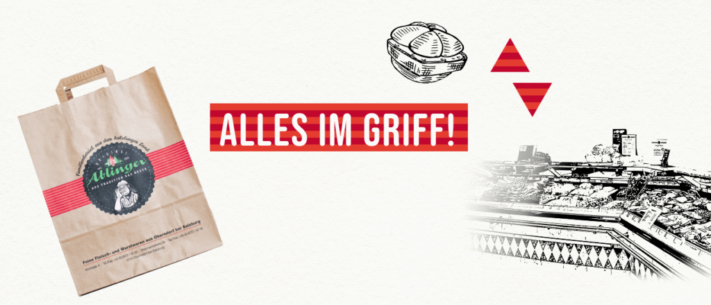 Ablinger Papiereinkaufstüte und Slogan "Alles im Griff"; Zeichnerische Darstellung einer Wursttheke im Hintergrund